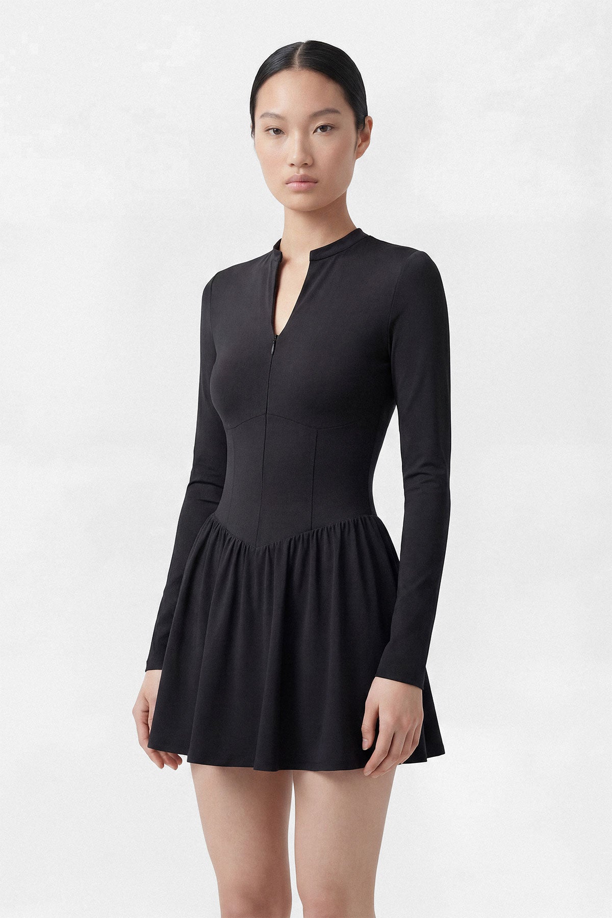 A black long sleeve golf dress with a zipper closure, built-in shorts and a side pocket