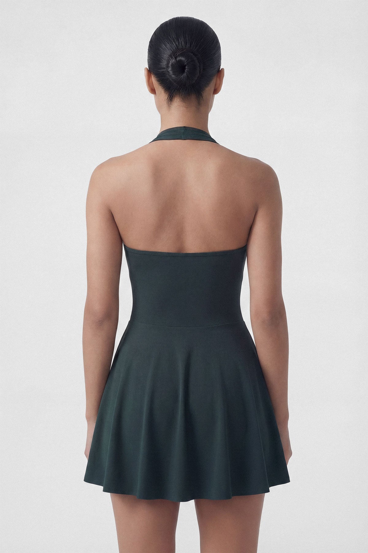 Dark green golf dress with built-in shorts and halter neck