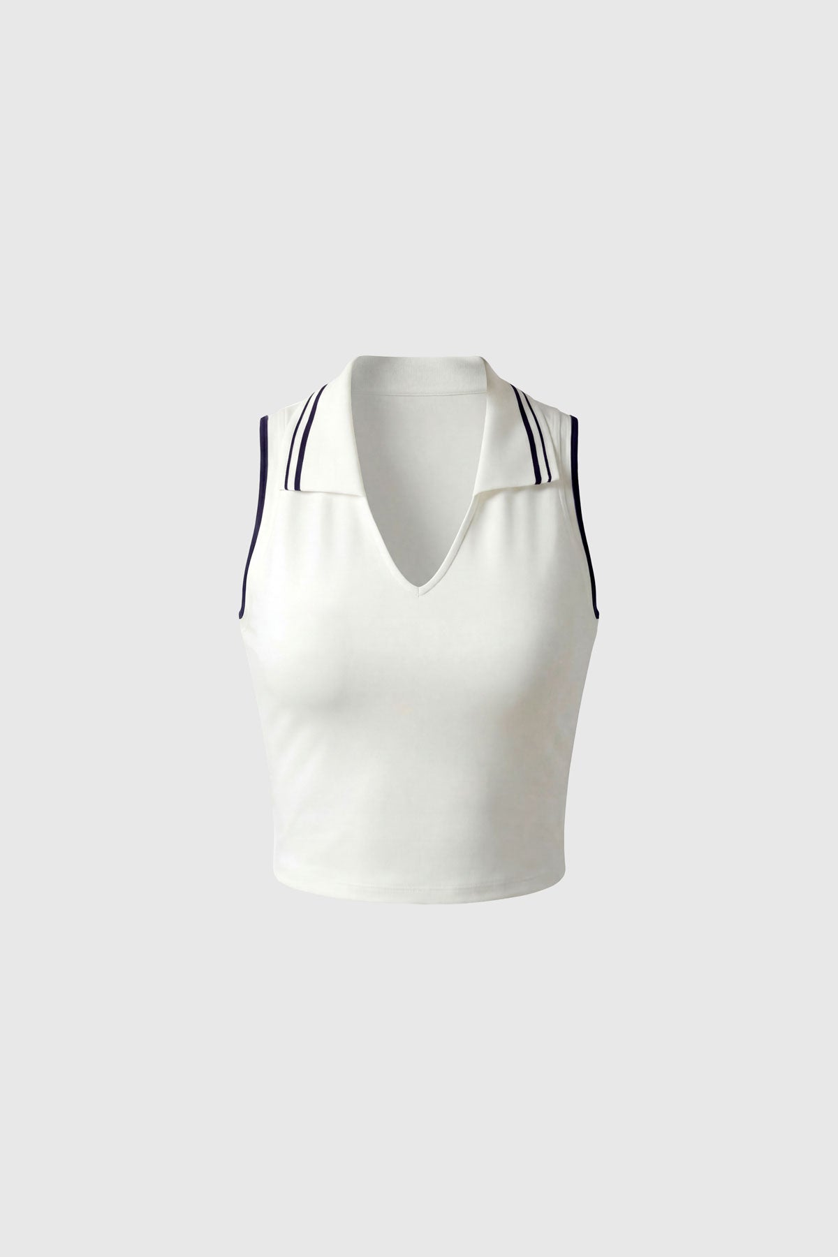 A white cropped collared polo top with navy stripe accents and built-in bra