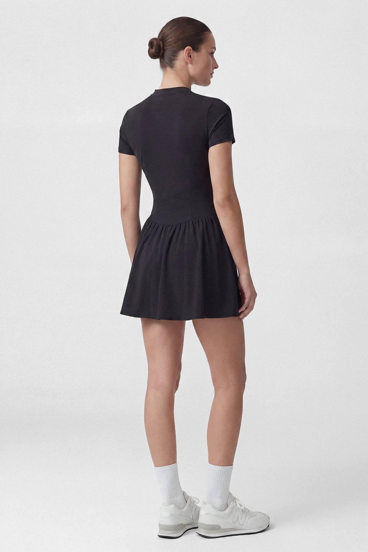 Black Common Player golf dress with built-in shorts and a hidden pocket