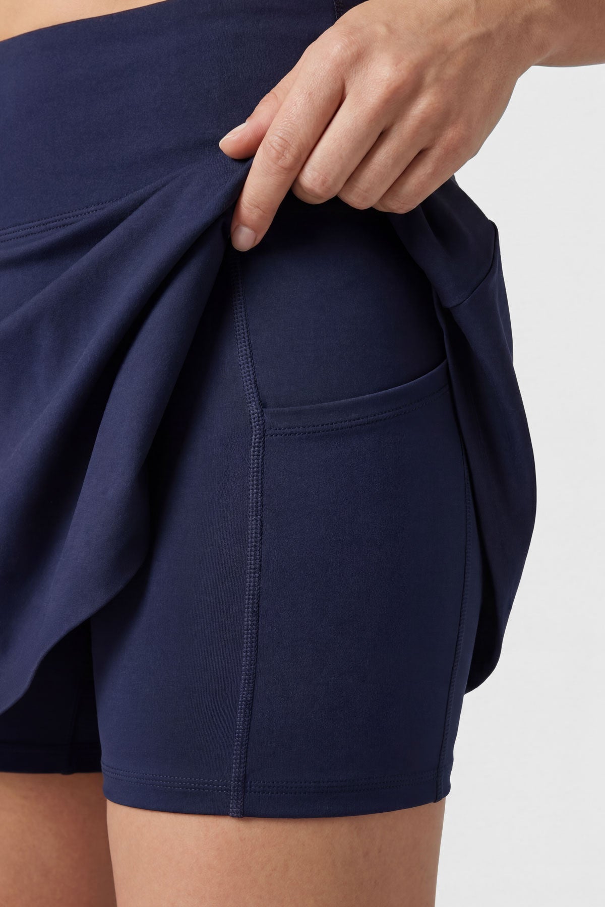Flared tennis skirt in navy blue with built-in shorts and pocket