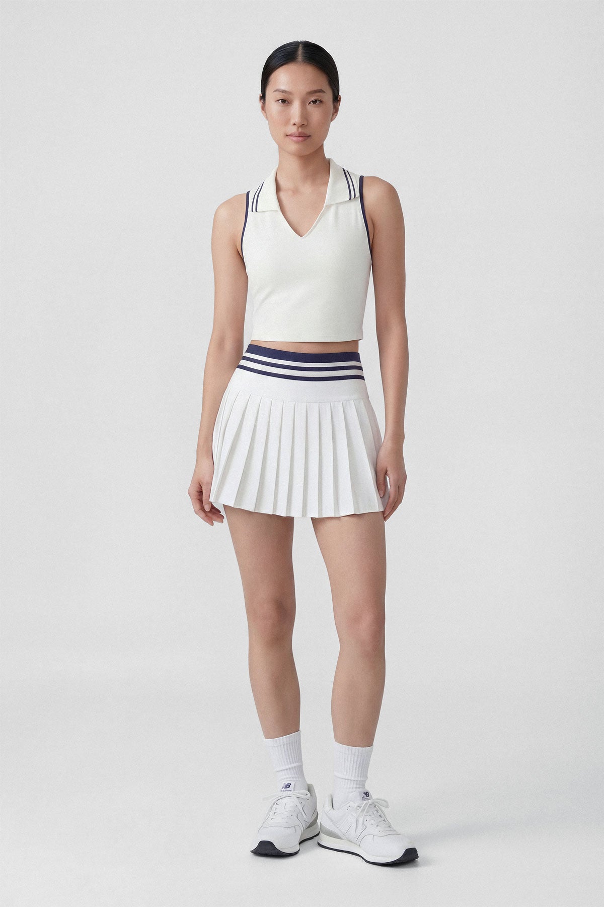 High-wasted white tennis skirt with a wide striped waistband and built-in shorts