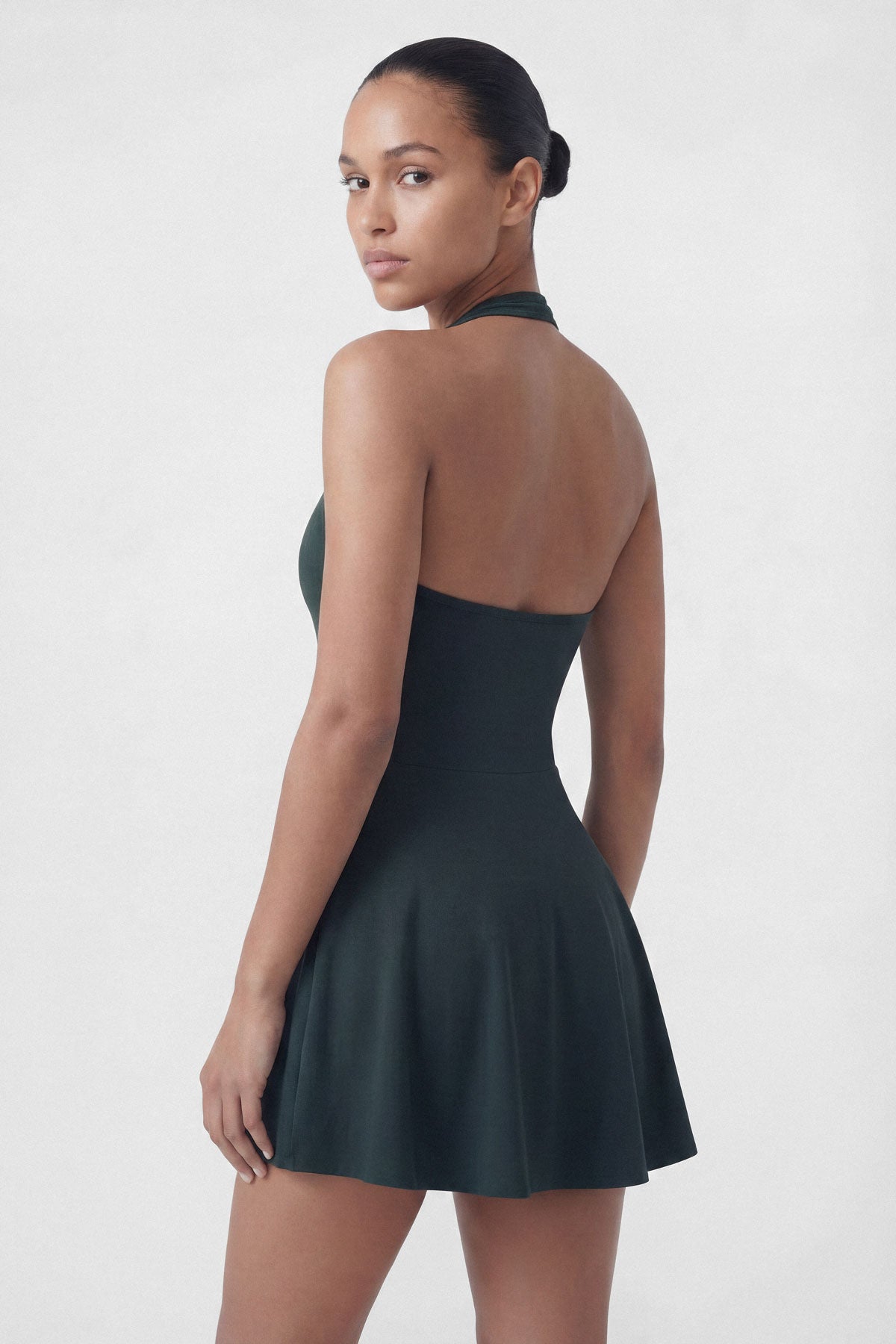 Dark green golf dress with built-in shorts and halter neck