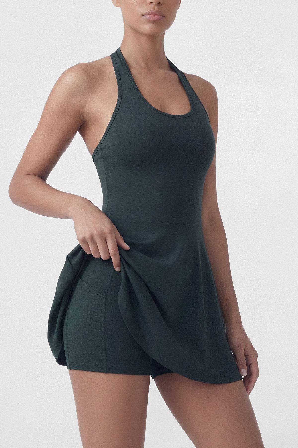 Dark green golf dress with built-in shorts and halter neck