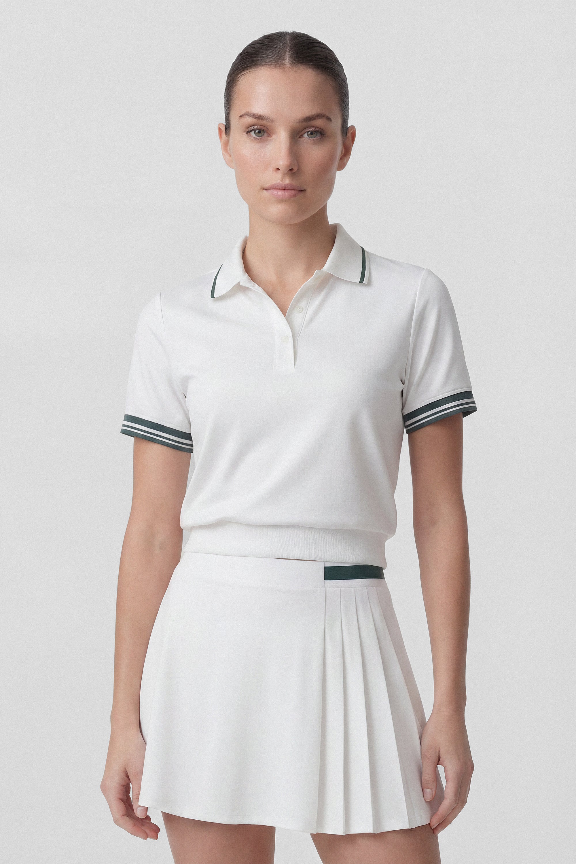 Model wearing a white golf polo top with green stripes