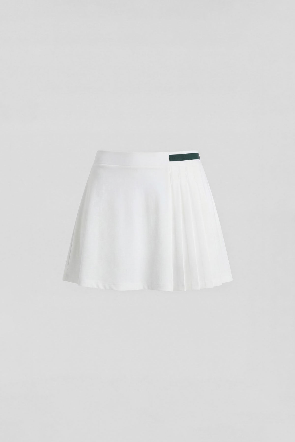 A white women's golf skort with dark green stripe detail and built-in shorts