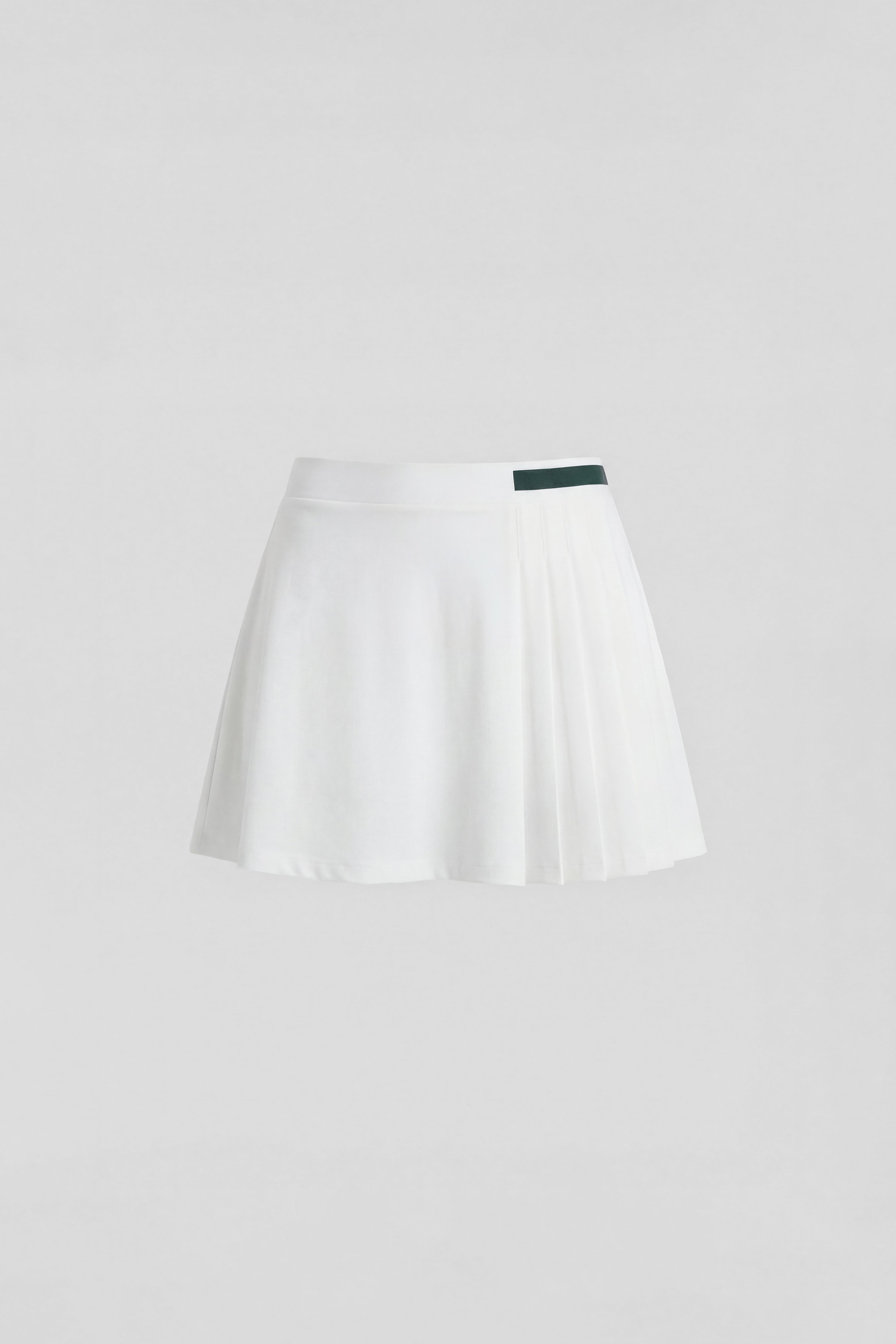 White pleated golf skirt with built in shorts and green stripe