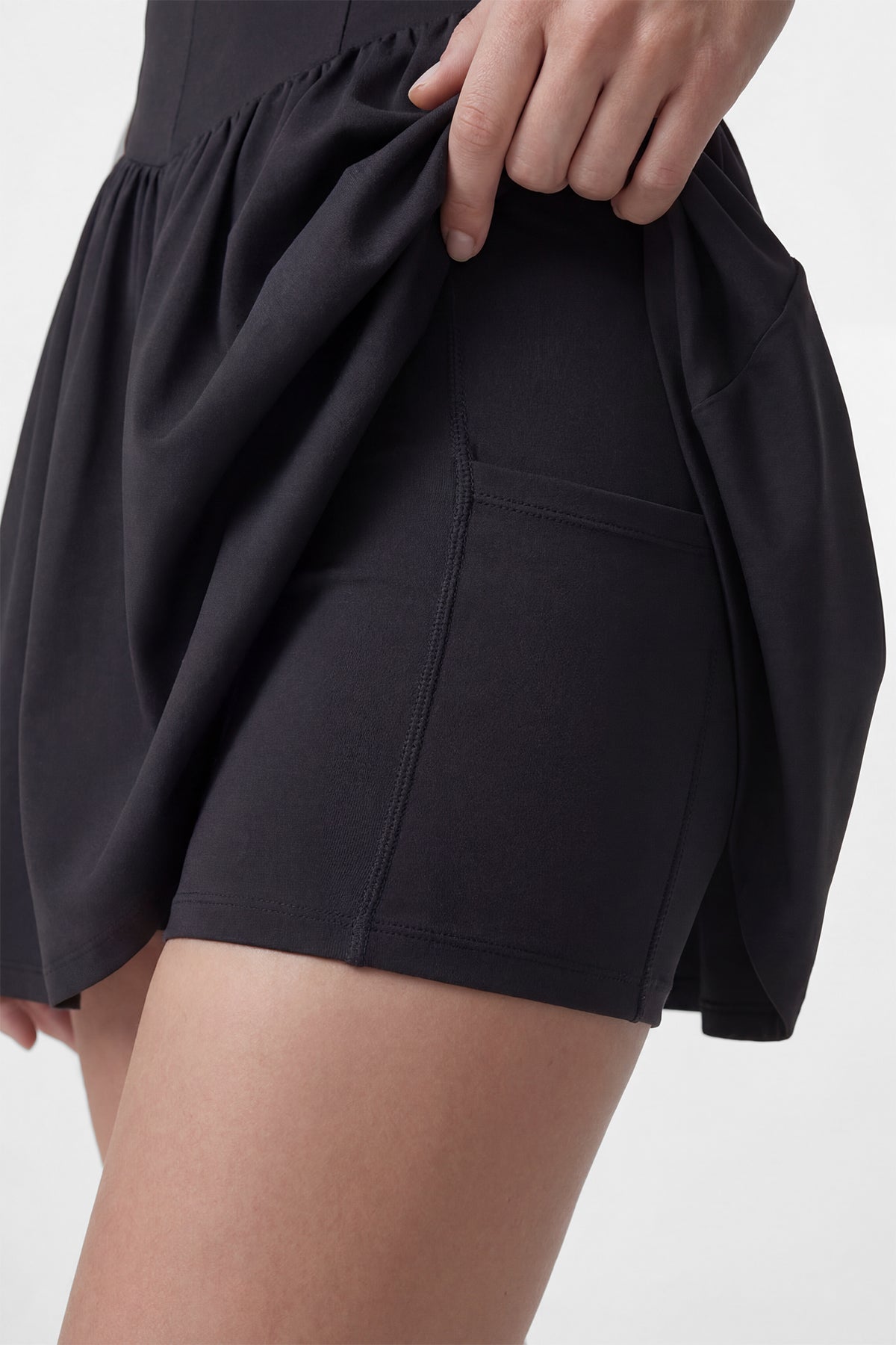 Black Common Player golf dress with built-in shorts and a hidden pocket