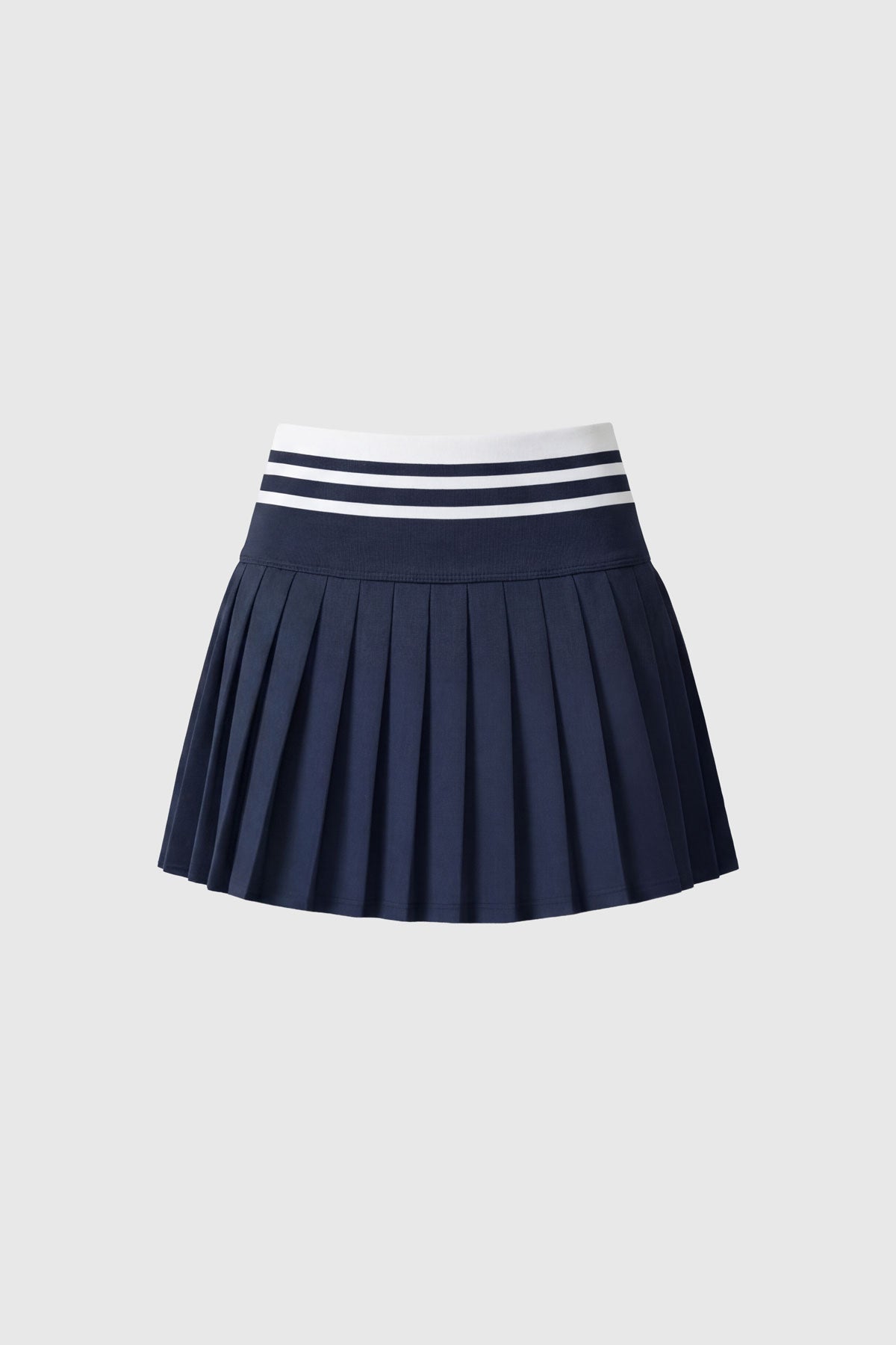 High-wasted navy tennis skirt with a wide striped waistband and built-in shorts