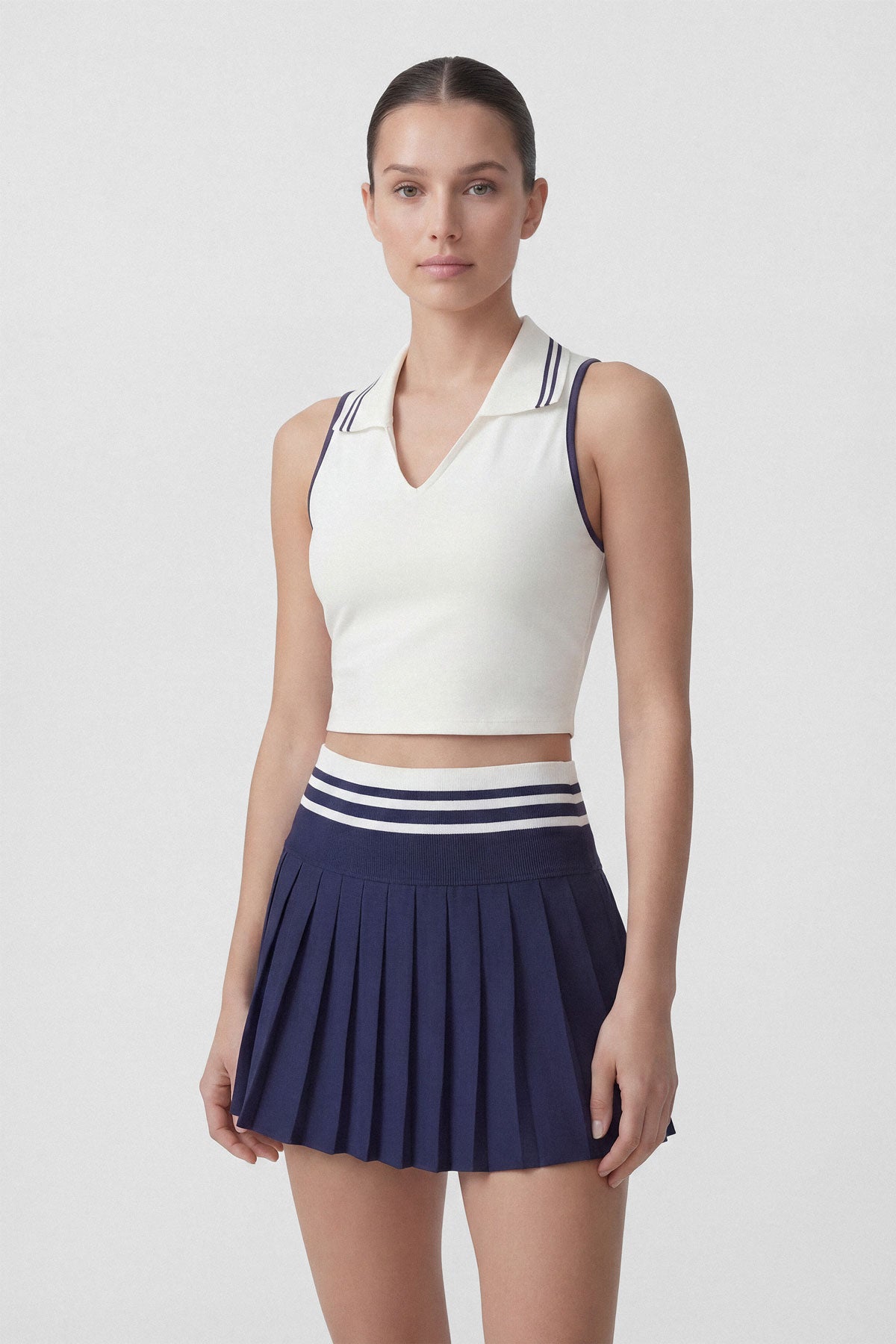 High-wasted navy tennis skirt with a wide striped waistband and built-in shorts