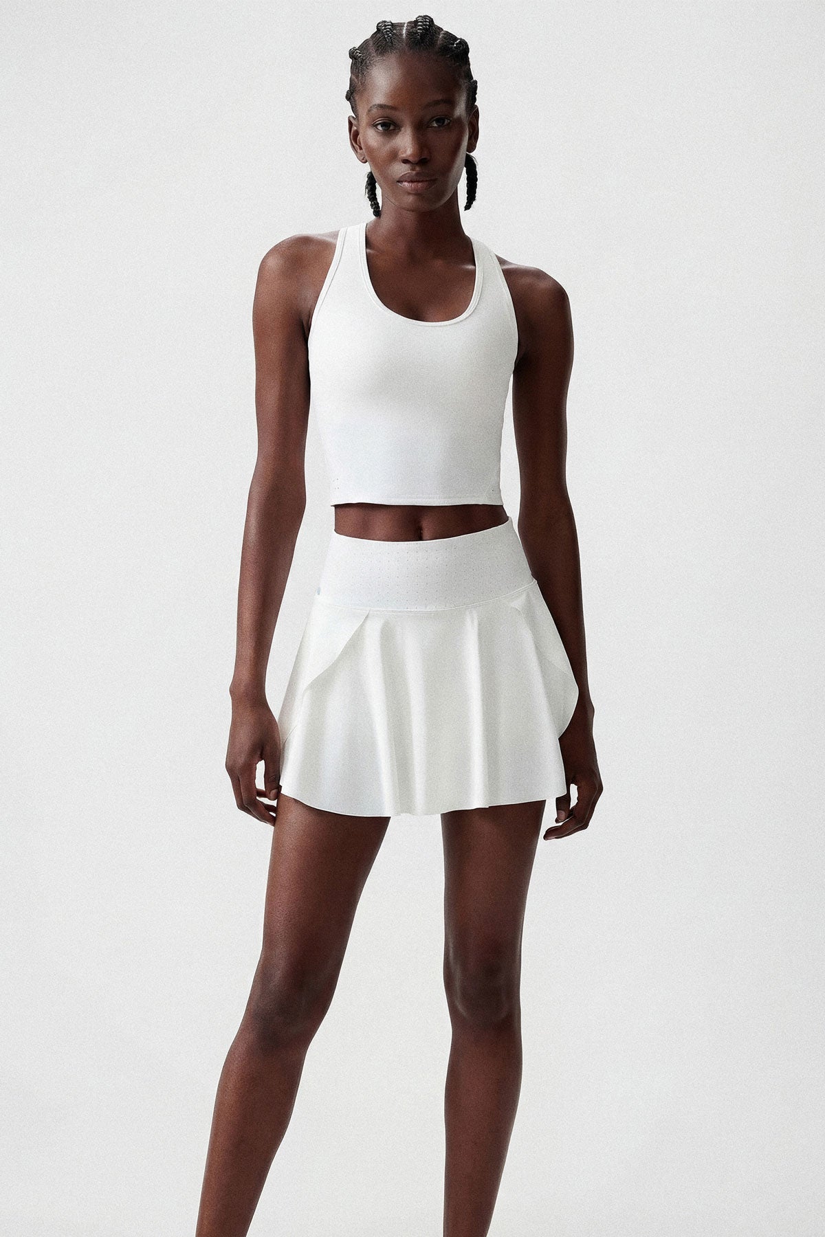 A flattering flared tennis skirt in white with built-in shorts and a side pocket