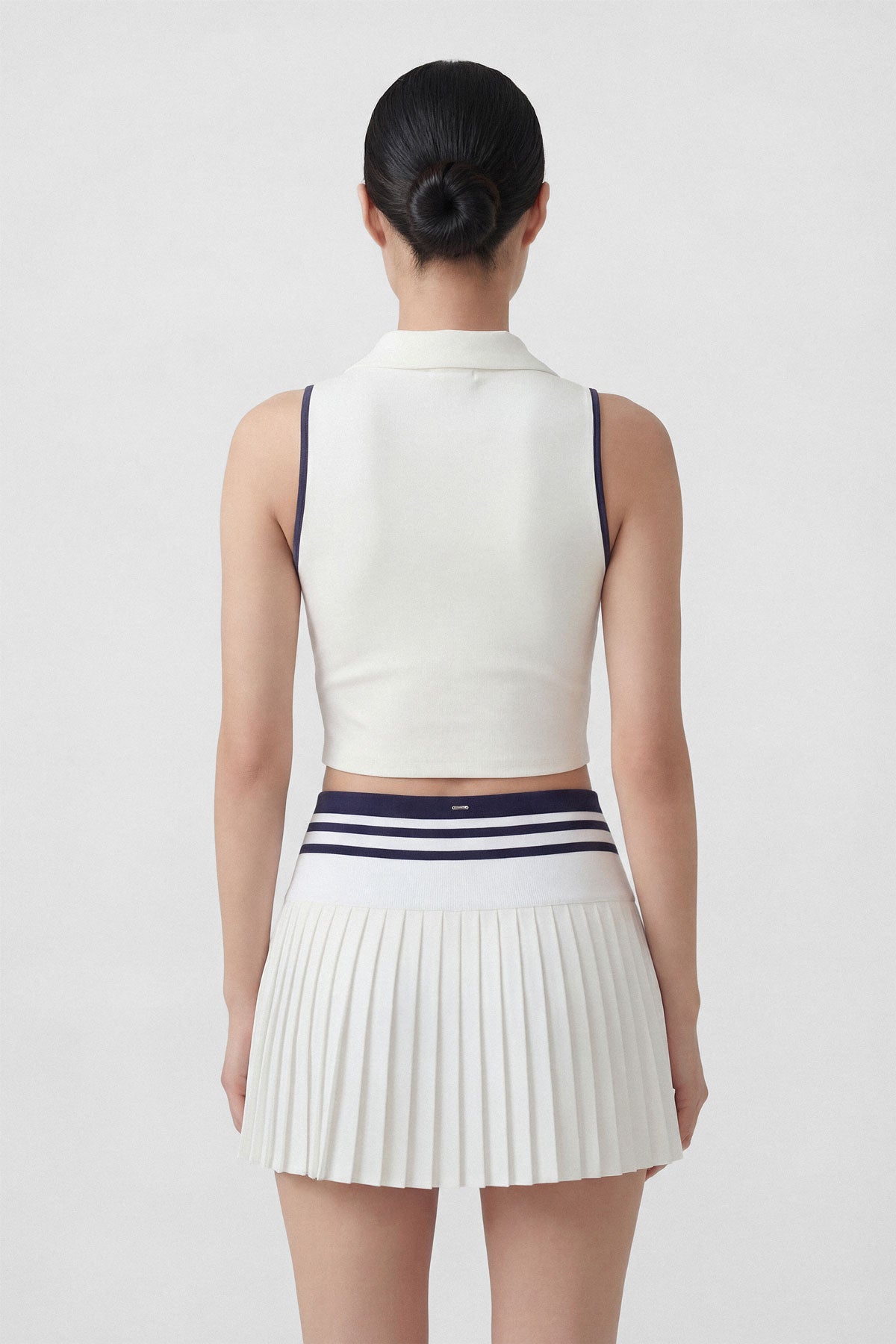 High-wasted white tennis skirt with a wide striped waistband and built-in shorts