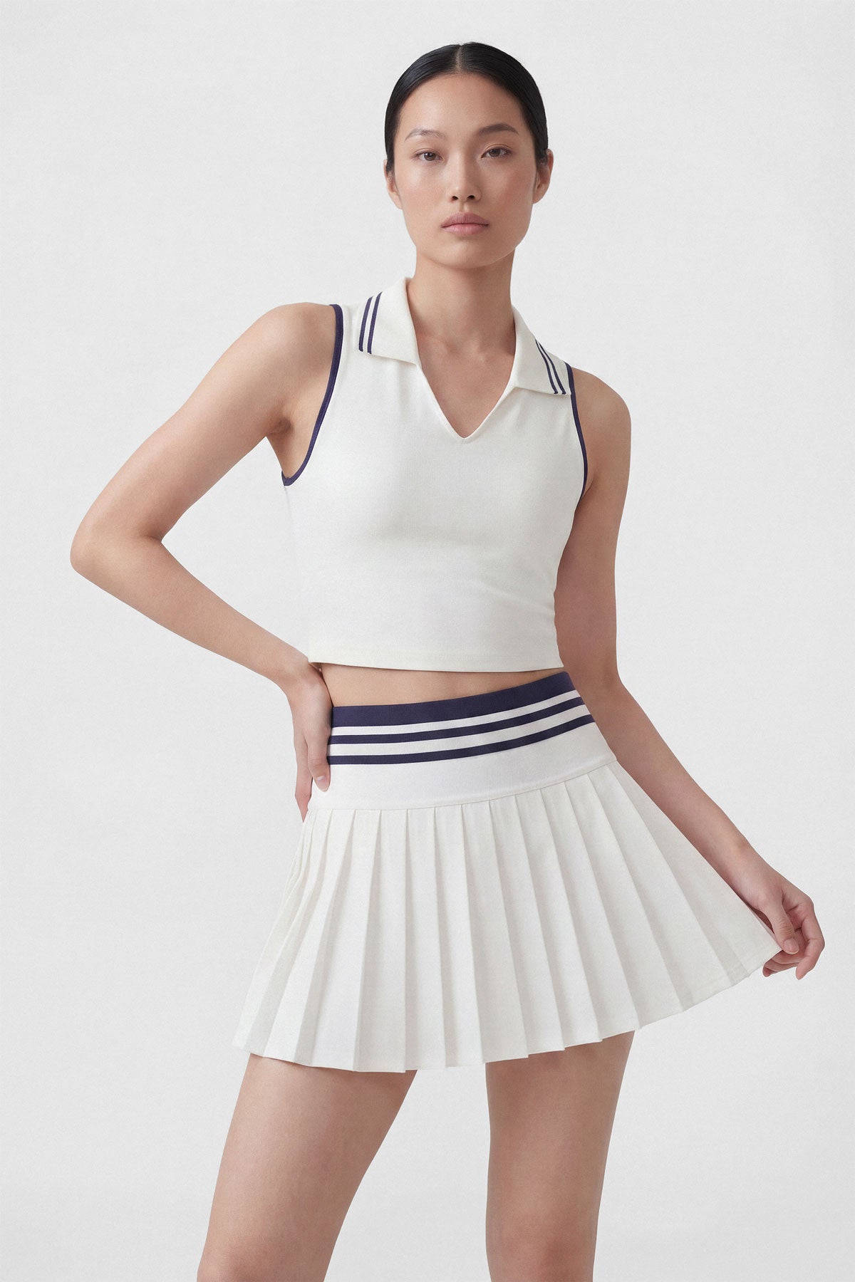 High-wasted white tennis skirt with a wide striped waistband and built-in shorts
